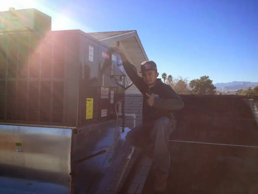 HVAC technician performing HVAC Inspection on a rooftop unit in San Marino